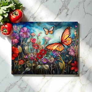 May include: Rectangular cutting board featuring a vibrant watercolor design of a butterfly and colorful flowers. The butterfly has orange and black wings. The flowers are red, purple, and pink. The background is blue and green.