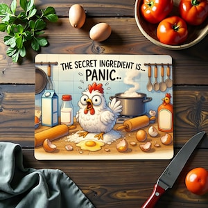 May include: A rectangular cutting board with a cartoon chicken illustration and the text "THE SECRET INGREDIENT IS... PANIC..". The image includes eggs, a rolling pin, a pot, and other kitchen items. The background is a wooden surface.
