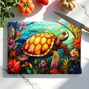 May include: A rectangular cutting board with a colorful illustration of a sea turtle swimming among flowers and aquatic plants. The turtle has a yellow and orange shell. The background features blue and green water. A knife and vegetables are in the background.