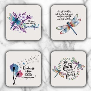 May include: Four square coasters featuring dragonfly designs and motivational quotes. One coaster says "Be your own kind of Beautiful." Another says "Accept what is, let go of what was, and have faith." The third says "Kindness is free, sprinkle that stuff everywhere!" The last says "Let your faith be greater than your fears."