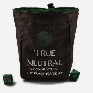 May include: A brown dice bag with a green interior and a green geometric design. The text "TRUE NEUTRAL" and a quote are printed on the front. Two green dice are next to the bag.
