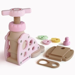 May include: A light pink and tan toy press with a screw mechanism, a handle, and a base. Several small, colorful, bear-shaped pieces and a pink screw are scattered nearby. The toy is designed for children.