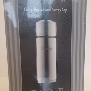 May include: A silver and black alkaline energy cup with the text "Classy Style" on the front. The cup is in a box with the Longrich logo and the text "Global Longrich, Centennial Longrich".