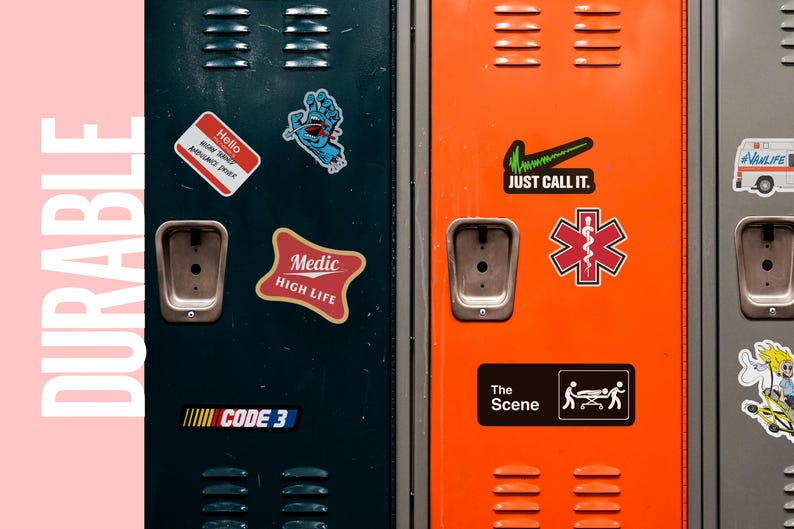 May include: Close-up of three colorful lockers with various stickers. The stickers include the text "Hello", "Medic High Life", "Just Call It", and a medical symbol. The lockers are dark teal, orange, and gray.