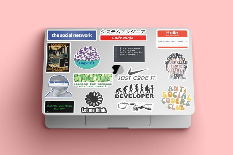 May include: A laptop computer with various stickers, including "the social network", "Code Ninja", "JUST CODE IT", "DEVELOPER", "ANTI SOCIAL CODERS CLUB", and "Let me think."