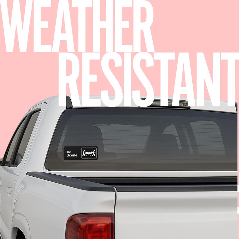 May include: A white pickup truck with a black rear window. A small black and white sticker on the window reads "The Scene" with a graphic of a person on a gurney. Large white text on a pink background reads "WEATHER RESISTANT".