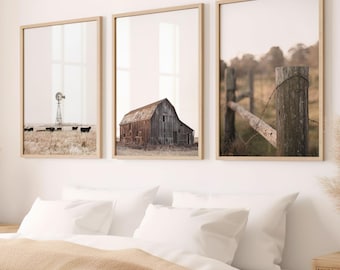 May include: Three framed prints of a rustic landscape. The left print shows a windmill and cattle in a field. The center print shows a weathered barn with a wooden door. The right print shows a close-up of a wooden fence with barbed wire.