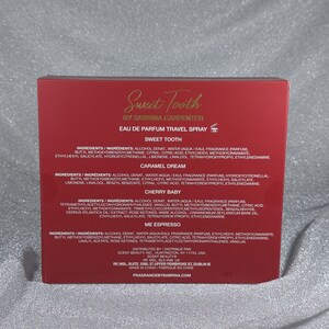 May include: A red box for a travel-sized Eau de Parfum spray by Sabrina Carpenter. The box features the text "Sweet Tooth" in gold script, along with ingredient lists for "Sweet Tooth", "Caramel Dream", "Cherry Baby", and "Me Espresso" fragrances.