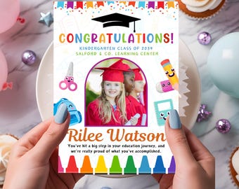 May include: A colorful graduation card with a photo of a young girl in a graduation cap and gown. The card says "Congratulations! Kindergarten Class of 2034 Salford & Co. Learning Center" and "Rilee Watson You've hit a big step in your education journey, and we're really proud of what you've accomplished."