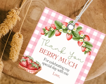 May include: Pink and white gingham thank you tag with a green leafy garland of red strawberries and white flowers. The text reads "Thank you Berry Much" and "For celebrating my special day with me. Love."