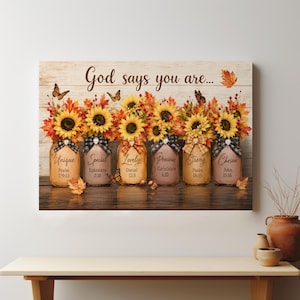 May include: A rectangular wall art print featuring the text God says you are above six glass jars filled with sunflowers and autumn leaves. Each jar is labeled with a word and a Bible verse, decorated with plaid ribbons and monarch butterflies.