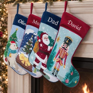 May include: Four personalized Christmas stockings with velvet cuffs featuring the names Olivia, Mom, Dad, and David. The stockings display needlepoint designs of a polar bear, a winter forest, Santa Claus, and a nutcracker against snowy backgrounds.