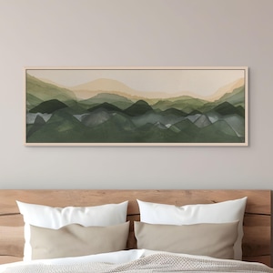 May include: A panoramic rectangular wall art piece featuring a layered watercolor landscape of rolling hills and mountains in shades of forest green, sage, and muted beige, enclosed within a thin, light-toned wooden frame.