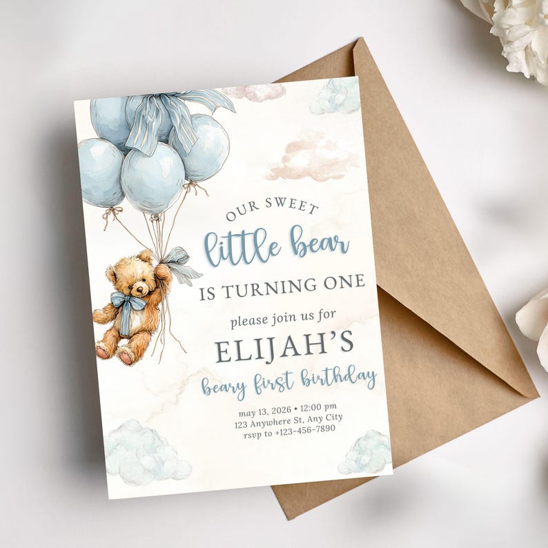 Blue bear first birthday invite template shown on a mockup, highlighting an easy to edit digital invitation for a teddy themed baby boy party.