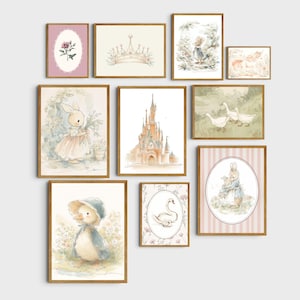 May include: A collection of framed watercolor art prints featuring whimsical illustrations. The artwork includes a castle, a crown, bunnies, a duckling, a swan, and floral elements. The frames are a warm brown color, and the overall theme is a soft, pastel color palette.