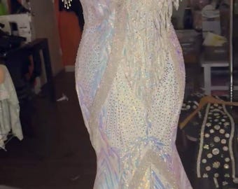 white and iridescent evening gown with ostrich feather headpiece