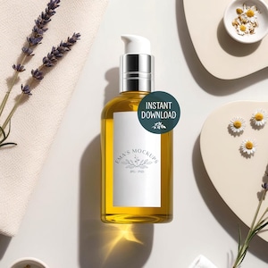 May include: A clear glass bottle with a silver pump top, filled with yellow liquid, and a white label. The label reads "Ema's Mockups" and "JPG / PSD". A green circle with the text "Instant Download" is on the bottle. Lavender and chamomile flowers are arranged around the bottle.