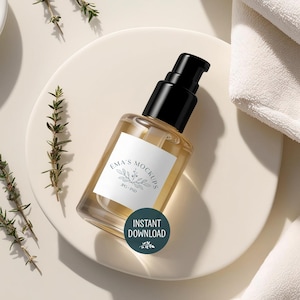 May include: A clear glass bottle with a black pump dispenser, filled with a light amber liquid. The bottle has a white label with the text "Ema's Mockups" and a botanical illustration. A teal circle with "Instant Download" is on the bottle.