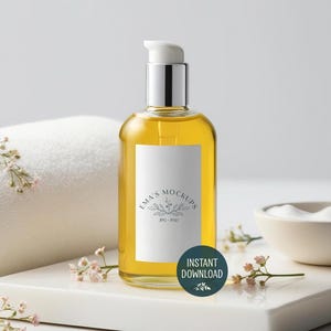 May include: A clear glass bottle with a silver pump top, filled with a yellow liquid. The bottle has a white label with the text "Ema's Mockups" and a floral design. A green circle with "Instant Download" is on the front.