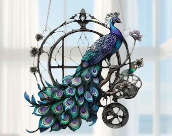 May include: A decorative peacock hanging ornament. The peacock is depicted with vibrant blue, green, and purple feathers, perched on a branch with floral accents. The ornament is framed by a circular, stained-glass-style design and hangs from a chain.