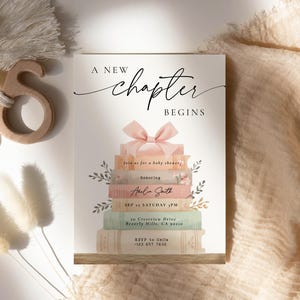 May include: Baby shower invitation with the text "A New Chapter Begins." The invitation features a stack of books with a pink bow on top. The invitation includes the name Amelia Smith and event details.