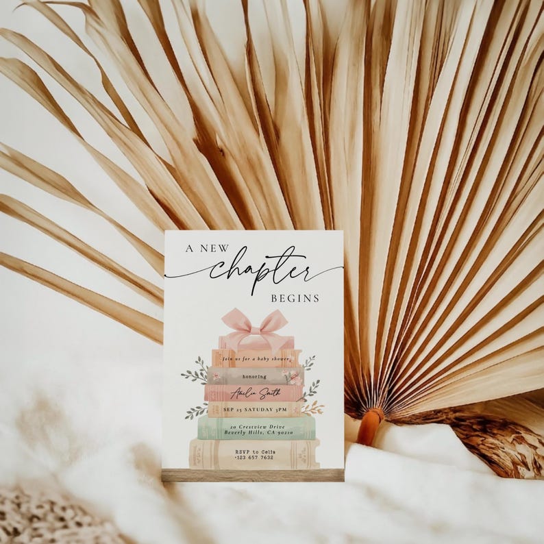 May include: A baby shower invitation card with the text "A New Chapter Begins". The card features a stack of books with a pink bow and floral accents. The invitation includes details like the honoree's name, date, time, and location.