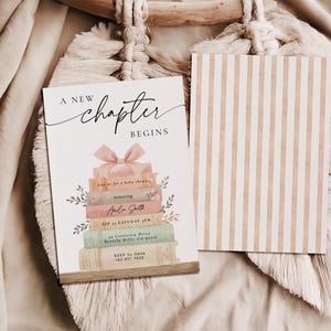 May include: A baby shower invitation with the text "A New Chapter Begins" and a stack of books topped with a pink bow. The invitation includes event details and a striped card.