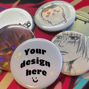 May include: A white ceramic mug with a black handle and the text "But First, Coffee" in a bold, black font. The mug is set against a blurred background, suggesting a cosy setting.