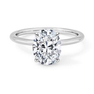 May include: A silver solitaire engagement ring with a large oval-shaped diamond.
