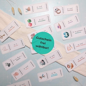 May include: A collection of rectangular paper vouchers featuring various illustrations and German text, including Gutschein, arranged around a central green circle with the text Gutschein frei wählbar. Each voucher depicts activities like wellness, climbing, games, massage, hiking, concerts, theatre, sauna, pottery, breakfast, and dining.