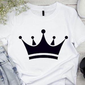 May include: White t-shirt with a black crown graphic.