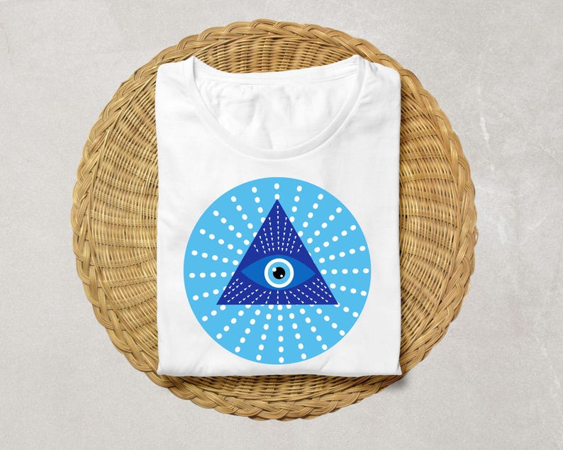 May include: White t-shirt with a blue and white evil eye design. The eye is inside a triangle with rays of light emanating from it.