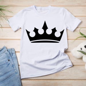 May include: White t-shirt with a black crown graphic.