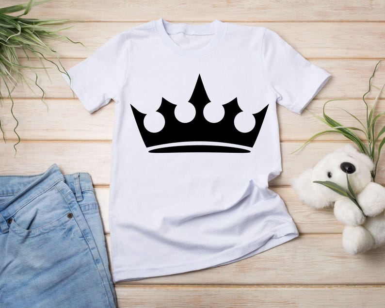 May include: White t-shirt with a black crown graphic.