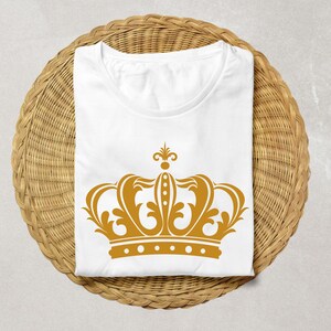 May include: White t-shirt with a gold crown graphic design.