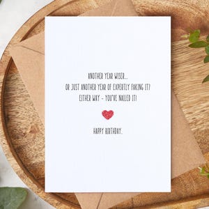 Another Year Wiser... Or Just Faking It? – Handmade Funny Birthday Card, A6 Greeting Card Embellished with Glitter Heart, Unisex