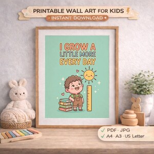 May include: A framed print with the text "I GROW A LITTLE MORE EVERY DAY" and a cartoon illustration of a child, sun, and ruler. The print is a printable wall art for kids, available for instant download in PDF, JPG, A4, A3, and US Letter sizes.
