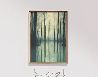 May include: A vintage photograph of a misty forest with tall trees reflected in the water. The image is in shades of green and blue, creating a serene and ethereal atmosphere.