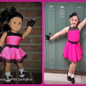 May include: Two girls wearing pink and black dance dresses with black gloves and black shoes. The girl on the left is a doll. The girl on the right is a human. The background is a brick wall and a row of green lockers.