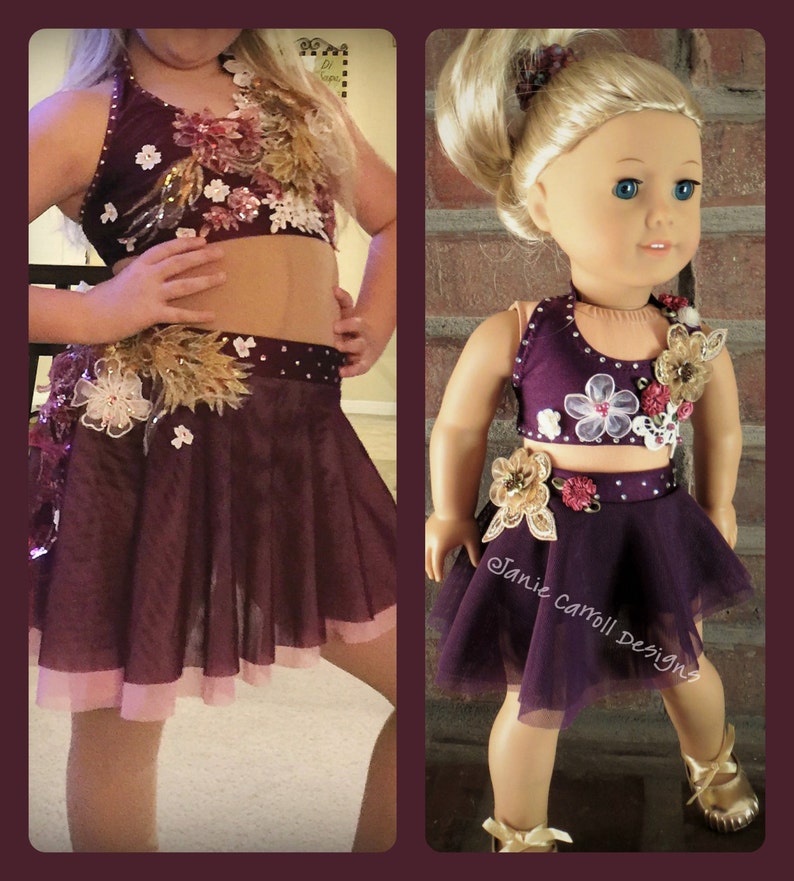 May include: A two-piece dance costume for a young girl. The top is a burgundy halter top with floral embellishments and rhinestones. The skirt is a burgundy tulle skirt with a pink lining and floral embellishments.