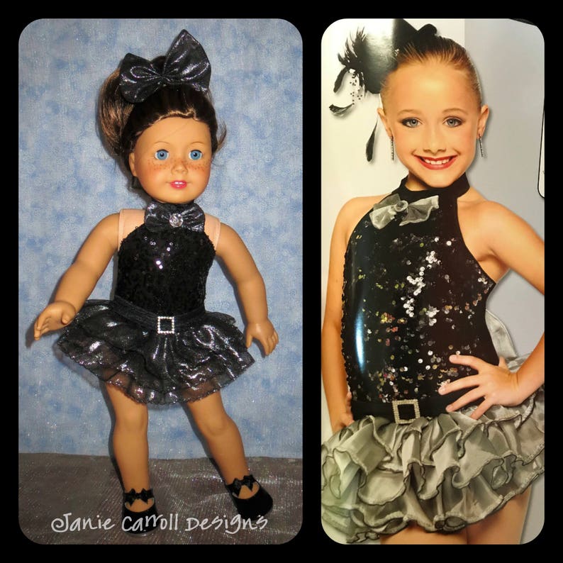 May include: A black and silver sequined dance costume with a ruffled skirt. The costume has a halter neckline and a bow at the neck. The costume is worn by a doll and a young girl.
