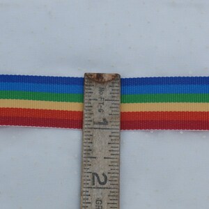 May include: A rainbow ribbon with red, orange, yellow, green, blue, and purple stripes. The ribbon is measured with a ruler that reads "No. FT-6" and shows 2 inches.