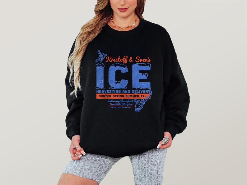May include: Black sweatshirt featuring the text "Kristoff & Sven's ICE" in blue and orange. The design includes character illustrations and the words "Harvesting and Delivery" and "Winter-Spring-Summer-Fall".