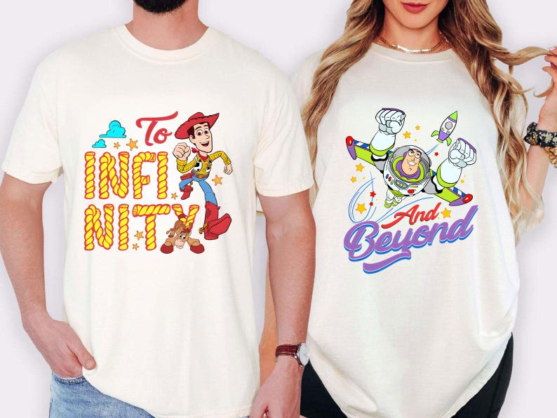 May include: Two cream-coloured t-shirts. One features Woody with the text "To Infinity" in yellow and orange. The other shirt displays Buzz Lightyear with the text "And Beyond" in purple and blue, with a rocket and stars.