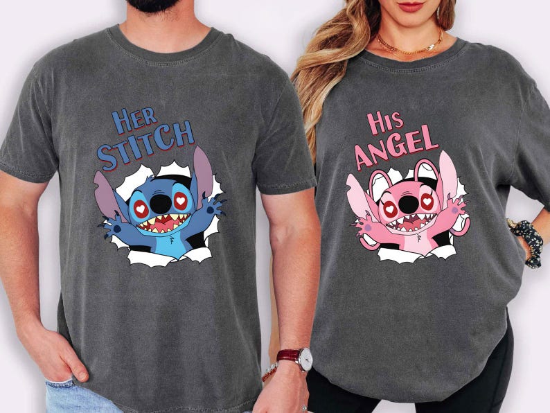 May include: Two charcoal grey t-shirts with matching graphics. One shirt says "Her Stitch" with a blue cartoon character. The other says "His Angel" with a pink cartoon character. Both characters are breaking through a white background.