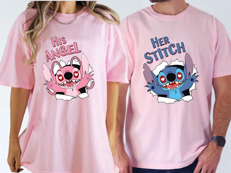 May include: Two pink t-shirts featuring cartoon graphics. One shirt says "His Angel" with a pink cartoon character. The other says "Her Stitch" with a blue cartoon character. Both characters are bursting through a torn paper effect.