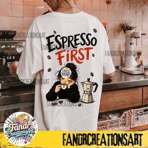 May include: A white t-shirt featuring the black text "ESPRESSO" and red text "FIRST" above an illustration of a person with a messy bun drinking from a small cup next to a moka pot, surrounded by scattered coffee beans and a small circular logo.