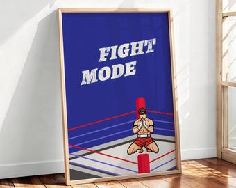 Könnte beinhalten: Ein gerahmtes, rechteckiges Wandbild mit tiefblauem Hintergrund und dem weißen, abgenutzten Schriftzug FIGHT MODE. Die Grafik zeigt eine kämpfende Person, die in einem Boxring mit roten Eckpfosten sowie blauen und roten Seilen kniet.