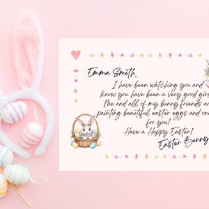 May include: A white card with pink and yellow floral borders. The card has a handwritten message that says "Emma Smith. I have been watching you and know you have been a very good girl! The and all of my bunny friends are painting beautiful Easter eggs and one is for you! Have a Happy Easter! Easter Bunny"