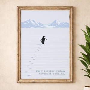 May include: A framed art print depicting a black penguin traversing a snowy expanse, with light blue mountains in the background. The print includes the text "When meaning fades, movement remains". The frame is a light brown colour.